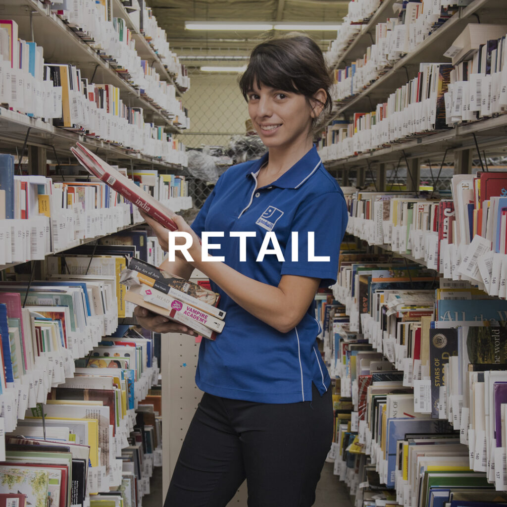Retail Jobs Button. Female employee worker putting books away.